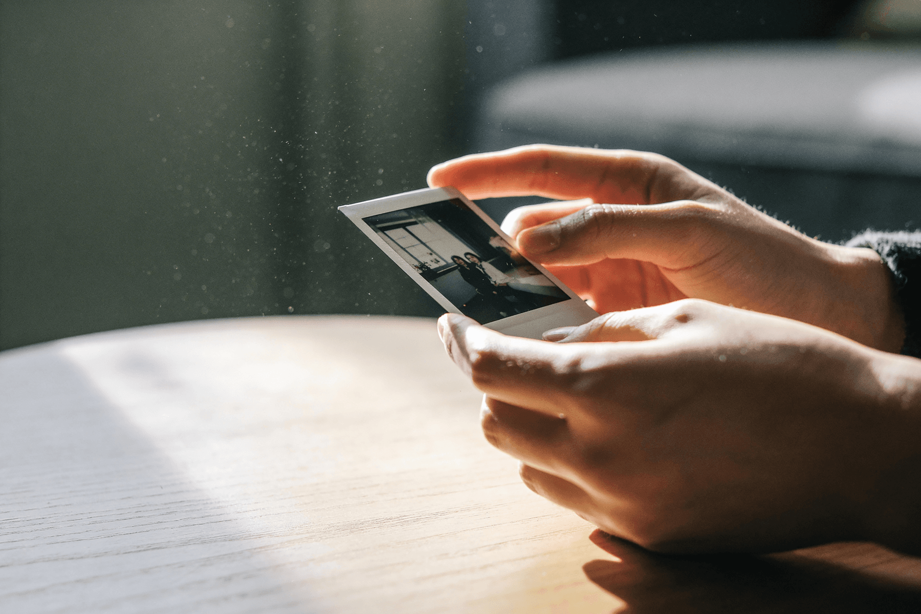 A hand holding a nostalgic family polaroid